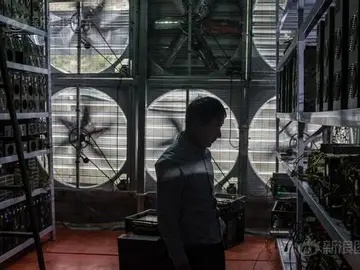 Cryptocurrency mining farm hosting Antminer rigs in climate-controlled warehouse