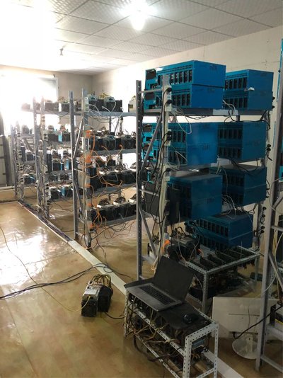 Expansive cryptocurrency mining farm with rows of mining machines operating 24/7